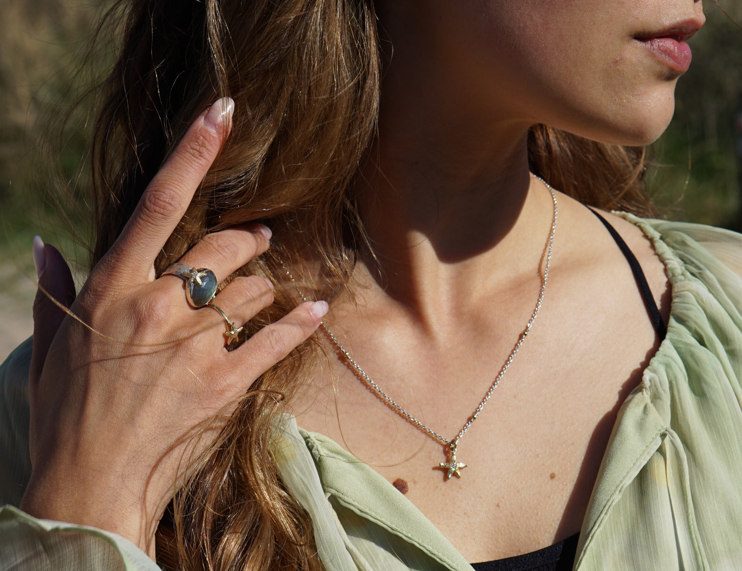 Silver necklace with gold balls and gold starfish with diamond