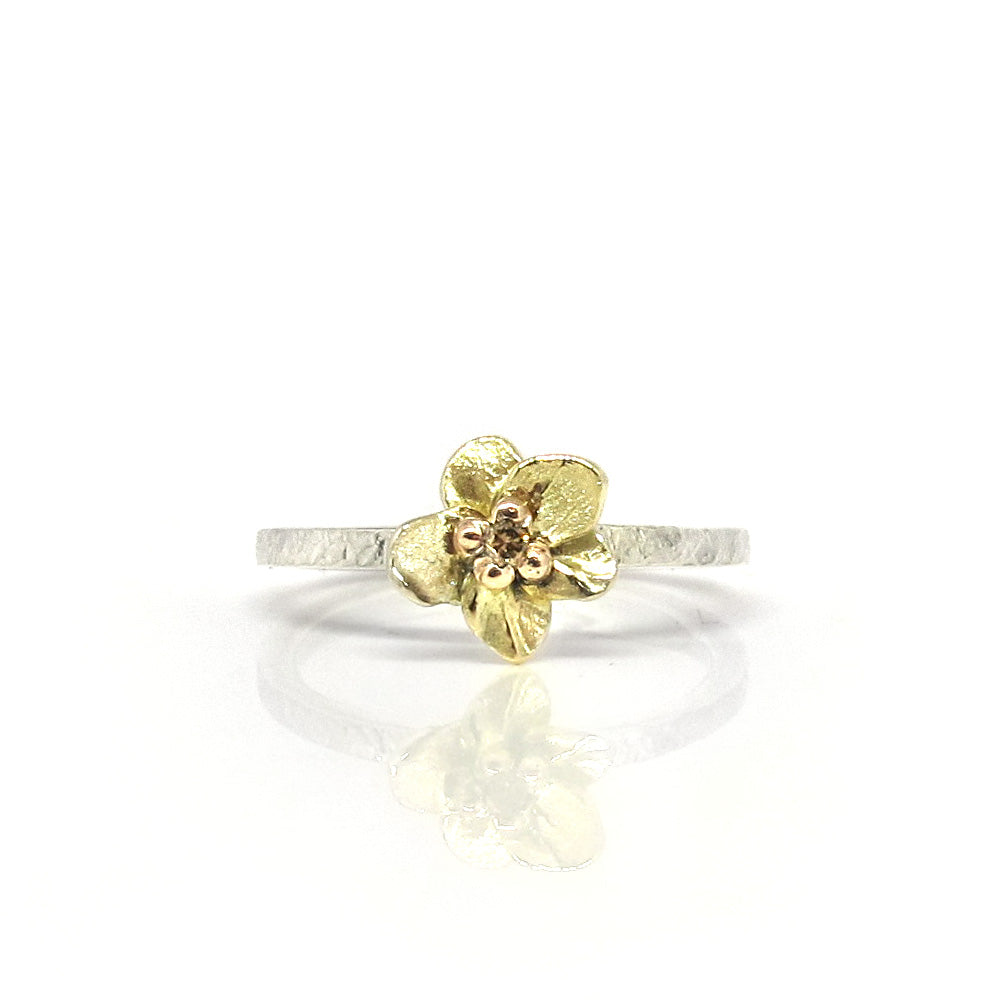 Silver ring with golden flower