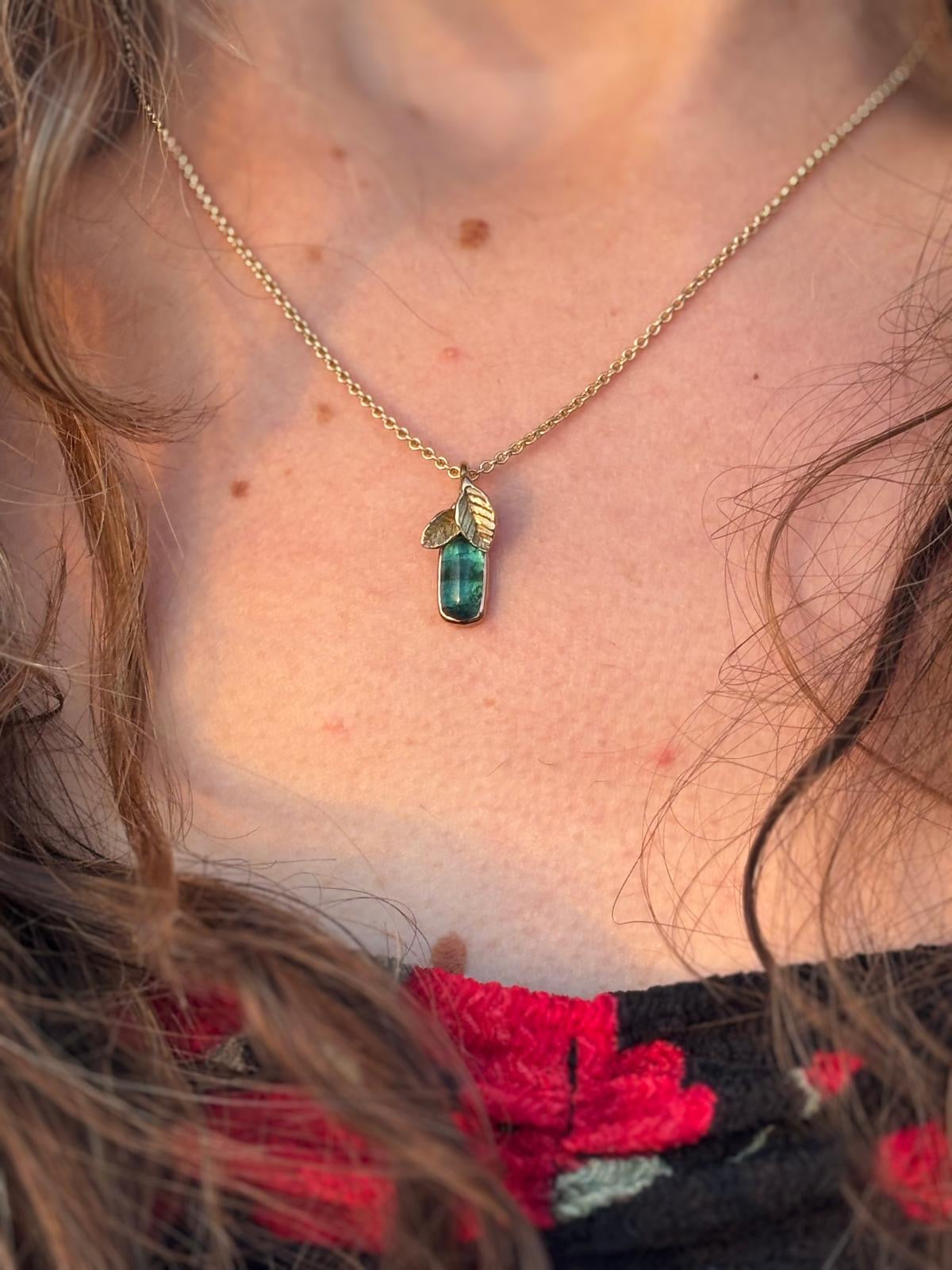 Gold necklace with green tourmaline