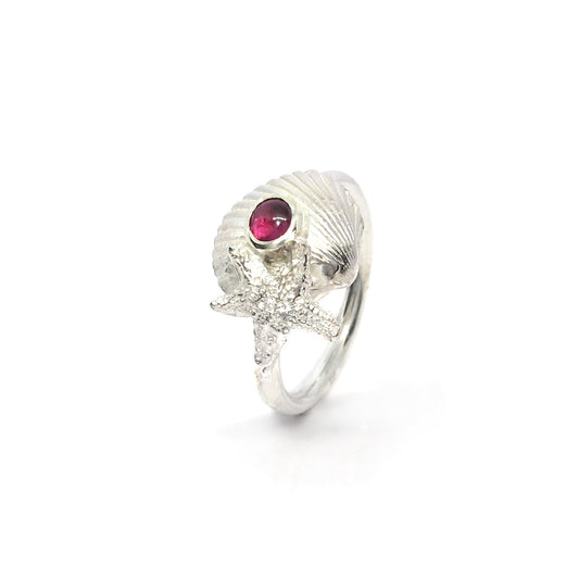 Silver ring with shell and starfish with dark pink tourmaline