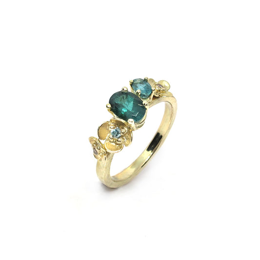 Gold engagement ring with tourmaline, flowers and diamond.