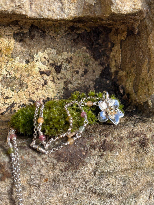 Necklace with silver flower with gold beads